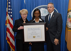 Photo of Assistant Attorney General Laurie O. Robinson, OJJDP Budget Analyst Anita Butler, and then-Acting Administrator Jeff Slowikowski.
